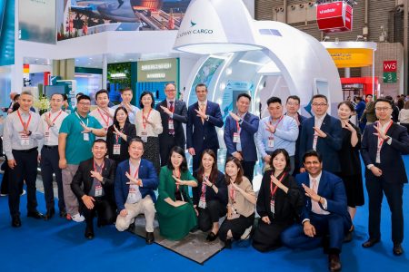 The Cathay Cargo team poses in front of their exhibition stand at the Air Cargo Shanghai event