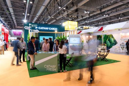 Show visitors gather around the Cathay Cargo exhibition stand at Asia Fruit Logistica 
