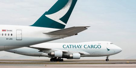 Two Cathay Cargo freighter planes parked on the tarmac