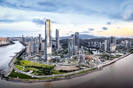 The Zhuhai skyline surrounded by water with clouds rolling overhead