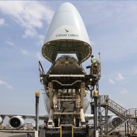 The view of Hong Kong international airport at sunset. The exterior of the building lit up inside
