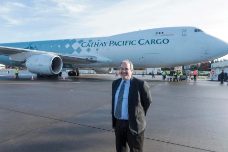 Fred Ruggiero standing in front of Cathay Cargo aircraft on tarmac