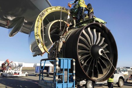 Anchorage team working on aircraft engine outdoors