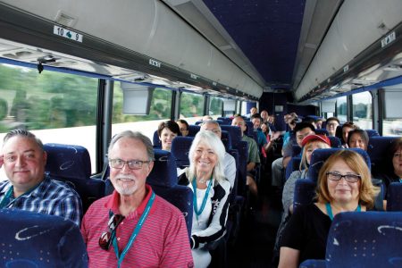 Group photo of customers and Cathay staff in bus