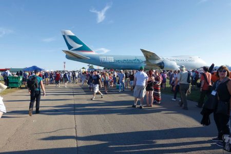 Cathay Cargo aircraft in Hong Kong Trader livery and crowd on tarmac