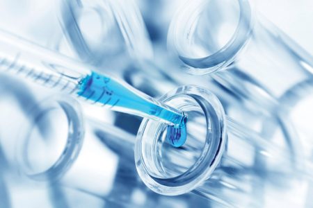 Laboratory dripper with blue liquid and test tubes