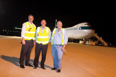 John Wagner and airport team with Cathay aircraft in background
