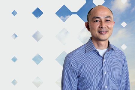 Orlando Wong photo with blue sky and diamond pattern background