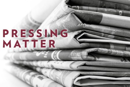 Black and white photo of newspaper stack with red text: "Pressing Matter"