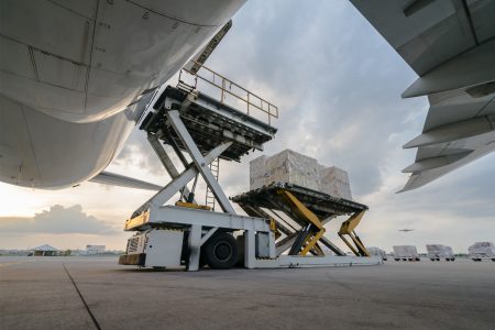 Shipments being loaded into aircraft with scissor lift