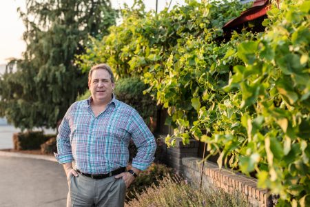 Patrick Allen outdoors with trees and bushes