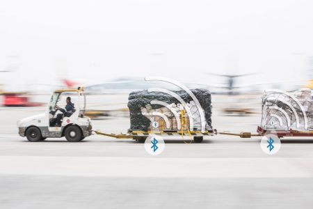 Cargo tractor with bluetooth signal graphics overlaid on shipments