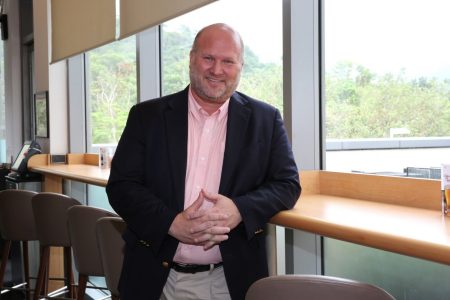 Christopher Day standing in front of a window