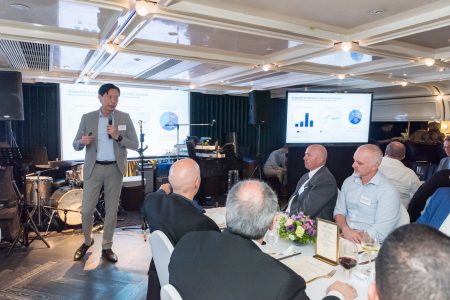 Tom Hoang presenting at dinner gathering