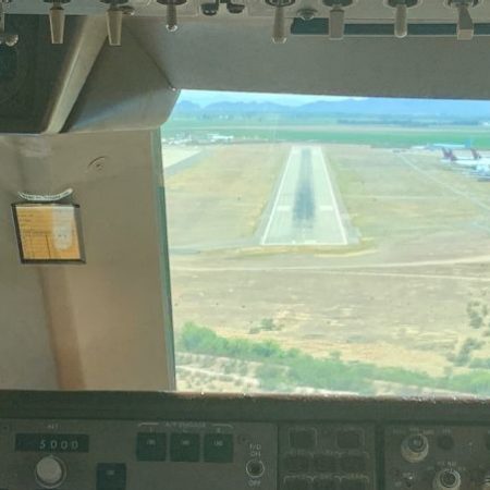 Cockpit window as flight approaches runway