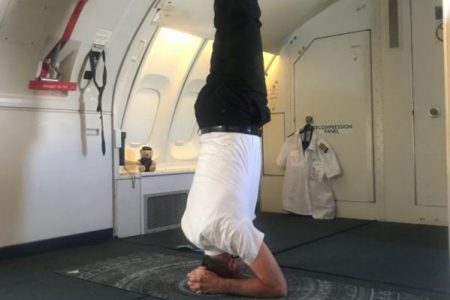 Pilot performing headstand on yoga mat