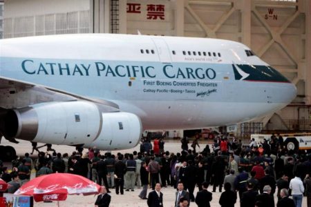 Crowd standing below Cathay 747 B-HUS outside hangar