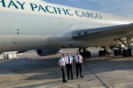 Pilots in front of a Cathay Pacific cargo plane