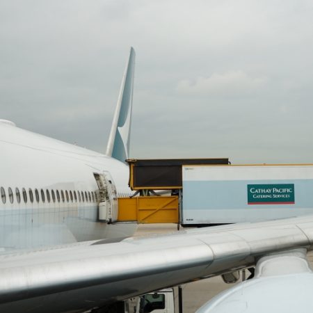 Cathay aircraft with cargo being loaded through door