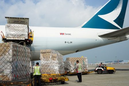 Airport crew loading Cathay aircraft with cargo