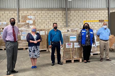 Team members pose with cargo shipment