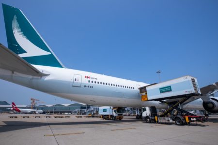 Cathay aircraft with catering truck on scissor lift next to door