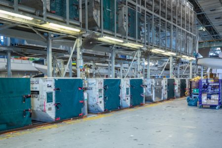 A cargo facility with containers lined up for processing