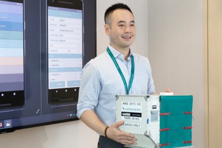 Calvin Hui holding a model ULD