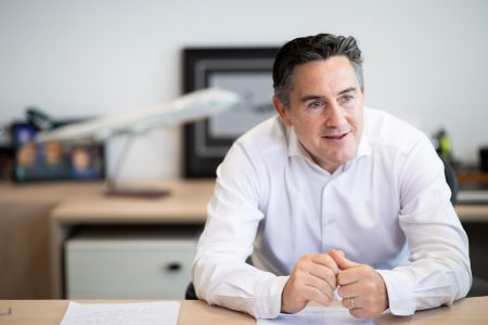 Tom Owen seated at desk