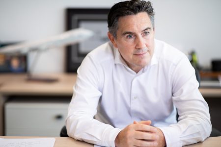 Tom Owen seated at desk