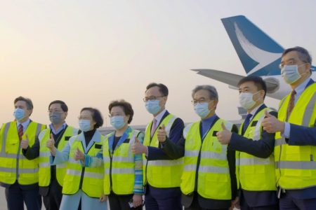 Cathay team posing with thumbs up on tarmac 