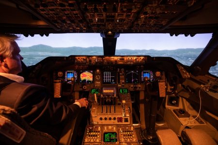 Pilot in flight simulator cockpit