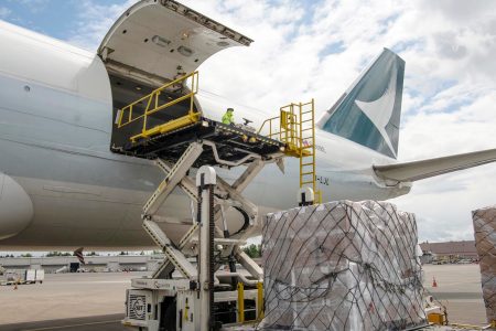 Cathay aircraft on tarmac being loaded with cargo