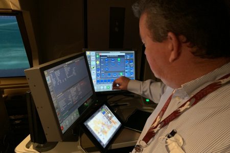 Manager adjusting flight sim settings on computer