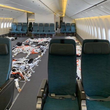 single row of passenger cabin seats and area with seats removed designated for cargo