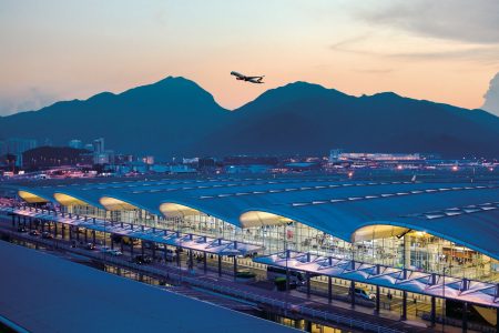 View of HKIA at dusk with Cathay aircraft taking off in background