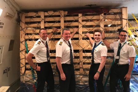 Pilots posing with crate