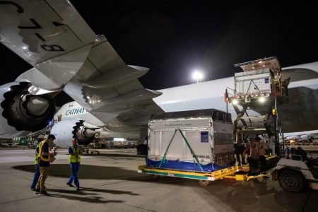 ULD next to aerial lift in front of aircraft