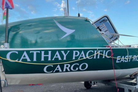 Boat with Cathay Cargo livery, transported across tarmac