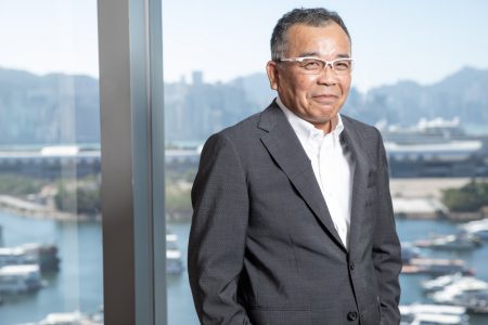 Tadashi Akiyama standing at window