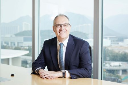 Mark Watts seated at desk