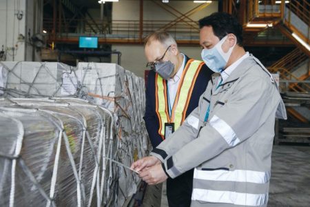 Mark Watts and staff member looking at packed shipment at cargo terminal