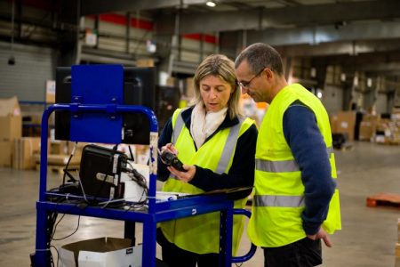 Mario Ceccon in cargo facility with female colleague