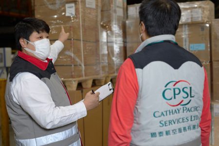 Toby Cheng in cargo terminal with colleague