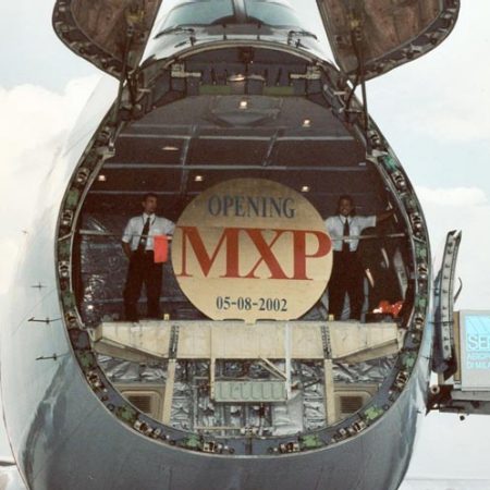 close up of cargo nose door open with MXP commemorative sign in 2002