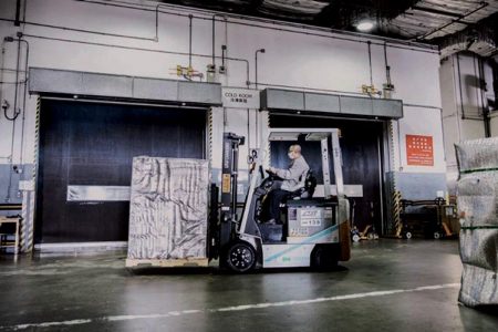 forklift in cargo terminal transporting cargo