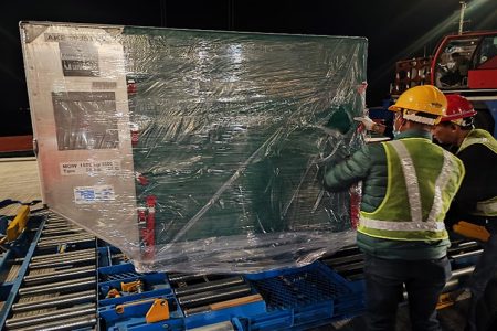 Logistics crew wrapping a ULD with transparent covering