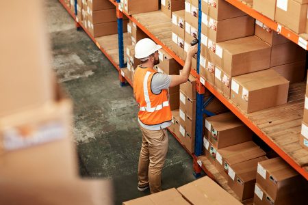 Warehouse staff scanning boxes on shelves