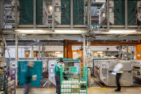 Hongkong post staff with trolley in cargo terminal