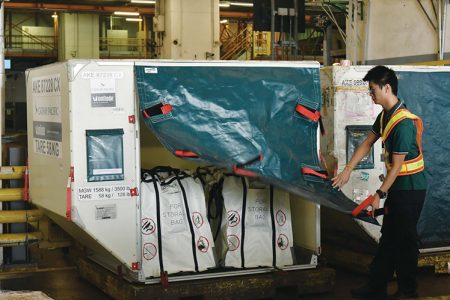 Staff loading fire containment bags in ULD